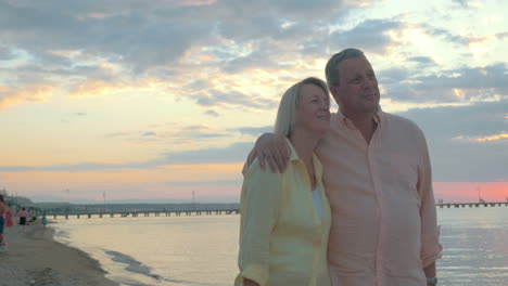 Loving-mature-couple-having-a-walk-on-the-beach