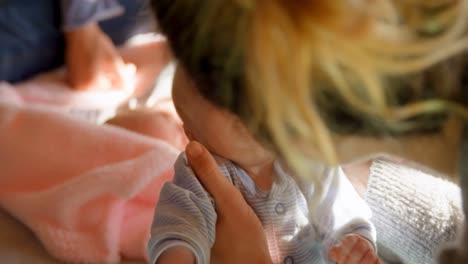 mother holding her baby boy at home 4k