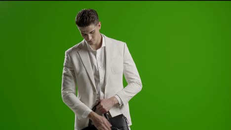 handsome young business man green screen using smartphone smiling taking photo selfie with phone