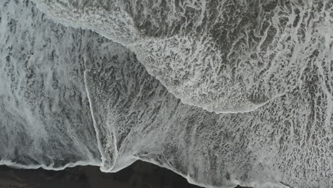 top down view of black volcanic beach