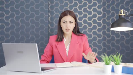 Young-business-woman-alerting-camera-with-stern-expression.