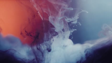smoke-like colored ink diffuses under the water