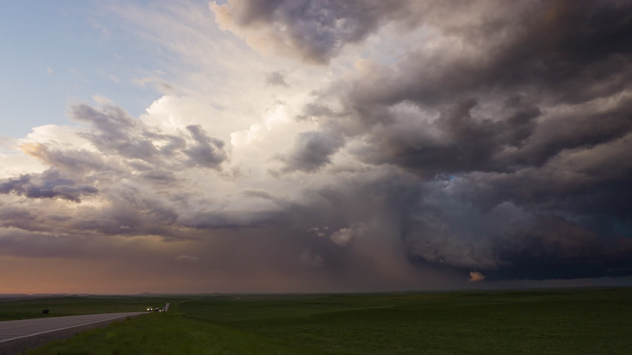 Storm clouds drift away and light up beautiful colors in the setting sun