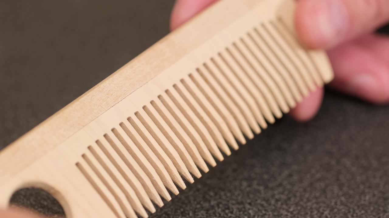 A smartphone with a green screen for your content. Telephone and wood screws on a wooden table. close up