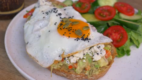 avocado toast with fried egg and salad