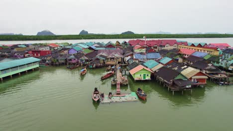 aerial pull out shot over floating village at panyee island, phang nga bay, thailand