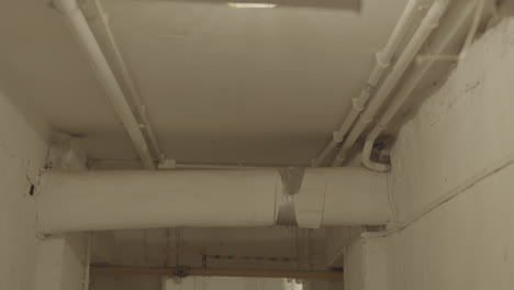 overhead pipes on a white ceiling in disrepair