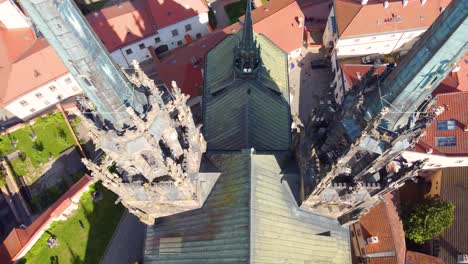 Majestic-towers-of-Brno-cathedral,-aerial-drone-close-fly-by