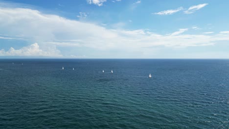 Far-tracking-shots-of-boats-off-the-shore-of-a-beach-in-Boca-Raton,-FL