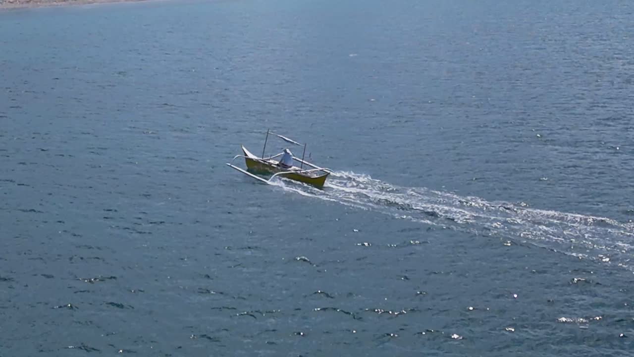 Drone Following a Fishing Boat in Mabua's Clear Waters in Surigao Philippines