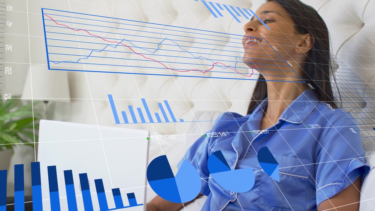 Woman on bed using laptop activating animated bar pie line charts overlaying her face for analytics