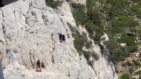 group of mountain climber on steep cliff of cote d azure in france. sunny day in summer. tracking slow motion shot.