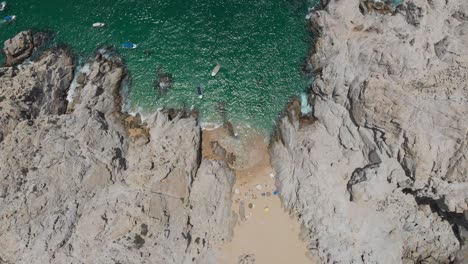 aerial view of beach between rock formations