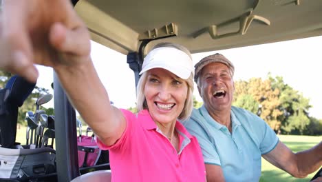 Two-golfers-driving-in-their-golf-buggy-