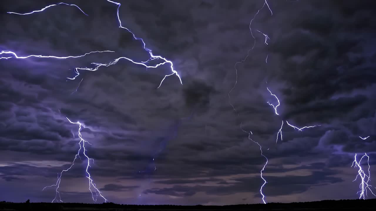 Dramatic wide-angle video capture of a stormy sky with vivid lightning bolts illuminating dark