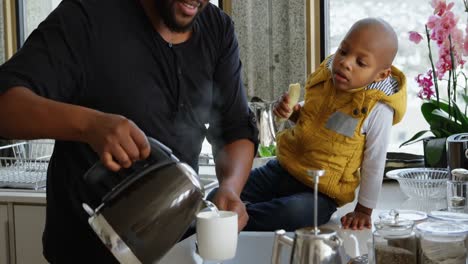 father and son preparing coffee in kitchen 4k