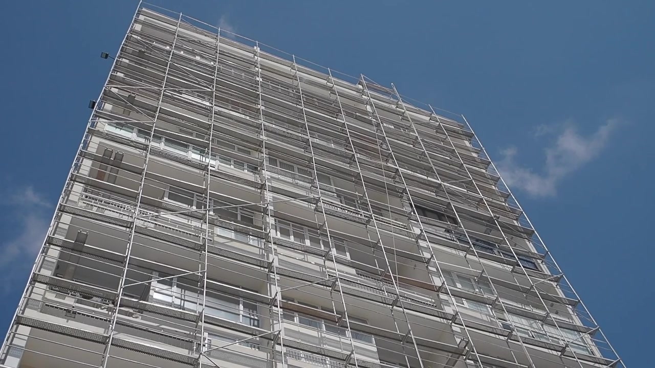 Edificio de apartamentos de gran altura en renovación con andamios