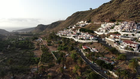 fantastica toma aerea recorriendo el valle de agaete y las casas y palmeras que se encuentran