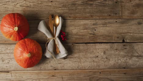 video of cutlery and pumpkins lying on wooden surface