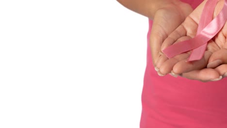 Hands-of-woman-dressed-in-pink-cradling-pink-cancer-ribbon