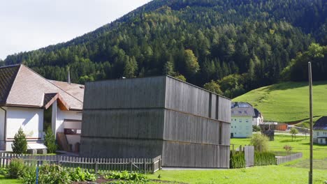 a remote house or resort in the valley surrounded by mountains and forest