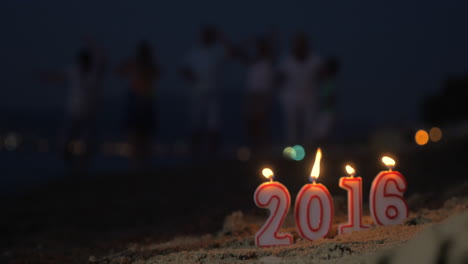 candles 2016 burns in sand on the beach