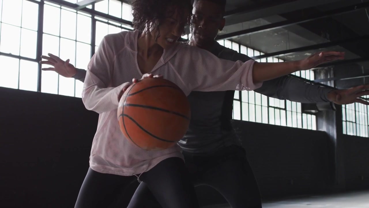 Woman running basketball drill in gym, VIBES overlays sliding, clearing, dribbling to protect ball