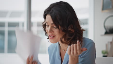 nervous executive complaining videocall holding papers in modern office closeup