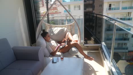 woman working on laptop on a balcony