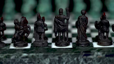 ancient marble chessboard with teal bronce knights as pawns slider macro-4