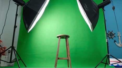 photo or video studio with two hexagone studio lights. green screen and fixed chair