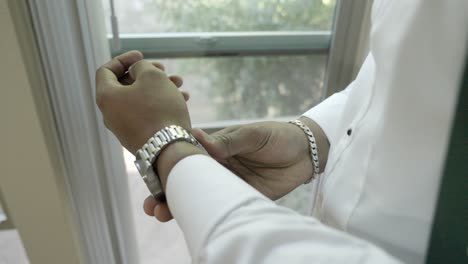 Groom-putting-on-watch-on-his-wedding-day