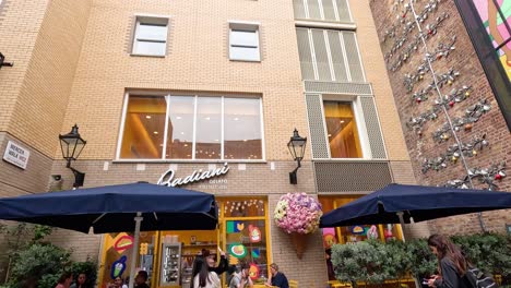 people walking near a colorful building