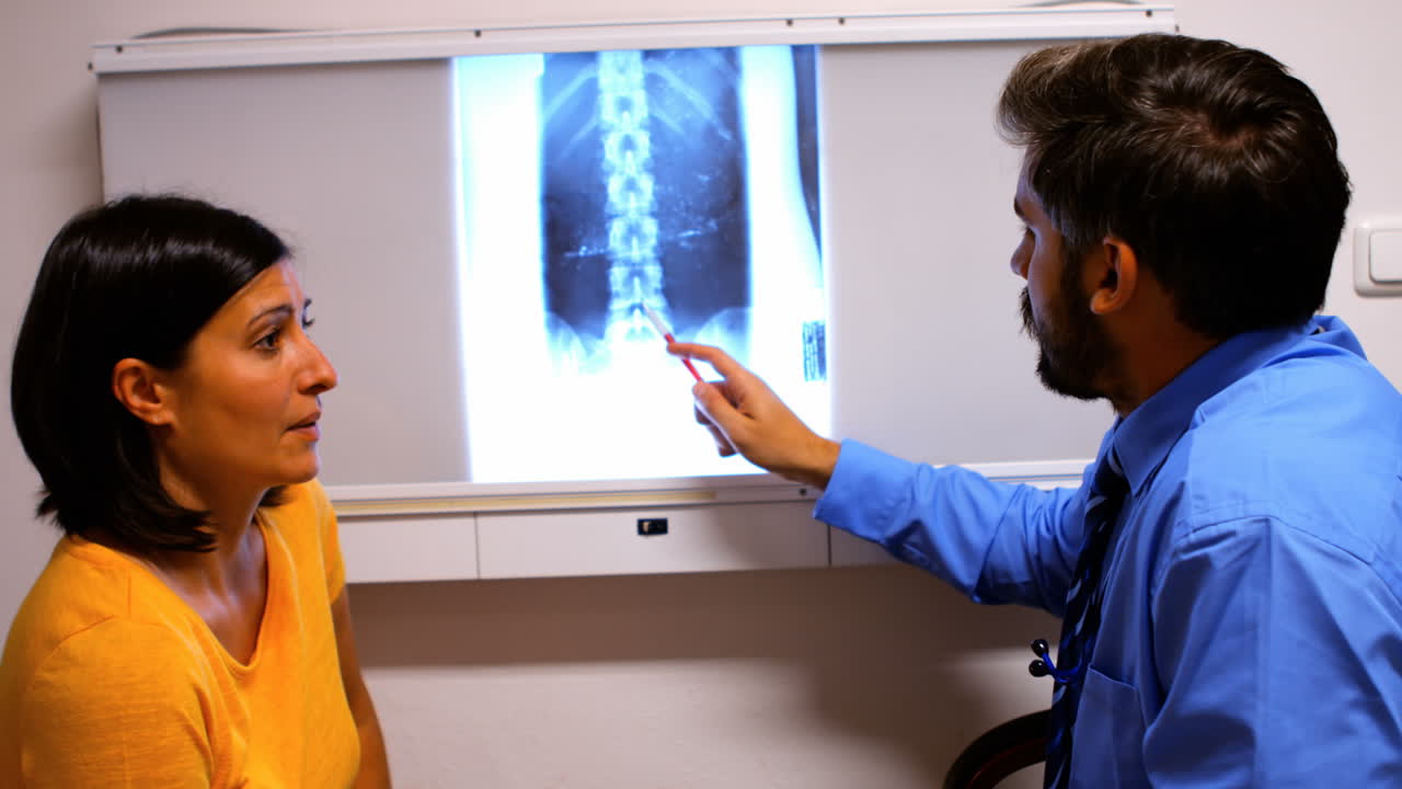 Doctor discussing x-ray with patient
