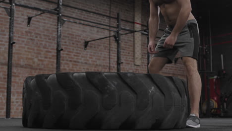 young sportsman flipping huge tire