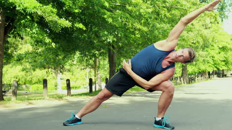 hombre en forma estirándose en el parque