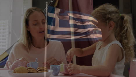 Enjoying tea time, woman and child with Greek flag animation overlay