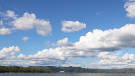 time-lapse of changing clouds over a calm lake