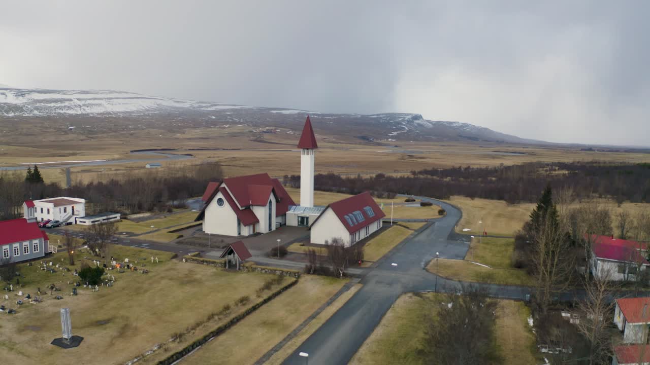 Drone View of Church in Iceland with Snowy Mountains on Background, Orbit Shot
