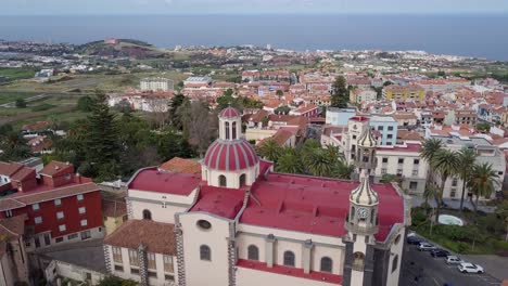Puerto-De-la-Cruz-tenerife-island-aerial-footage-of-old-church-in-the-little-village-in-spain-with-ocean-view