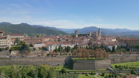 rapid approach to the medieval city of bergamo alta nestled on the green hills, near orio al serio airport during a beautiful sunny day