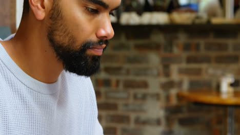 man using laptop in cafe 4k