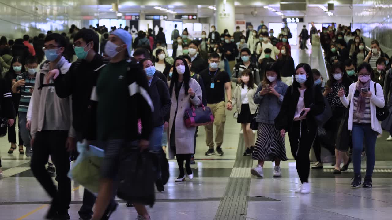 Hong Kong, China - March 10, 2020: Slow motion of people wearing medical face masks at metro. People Wearing Mask because of Corona Virus.
