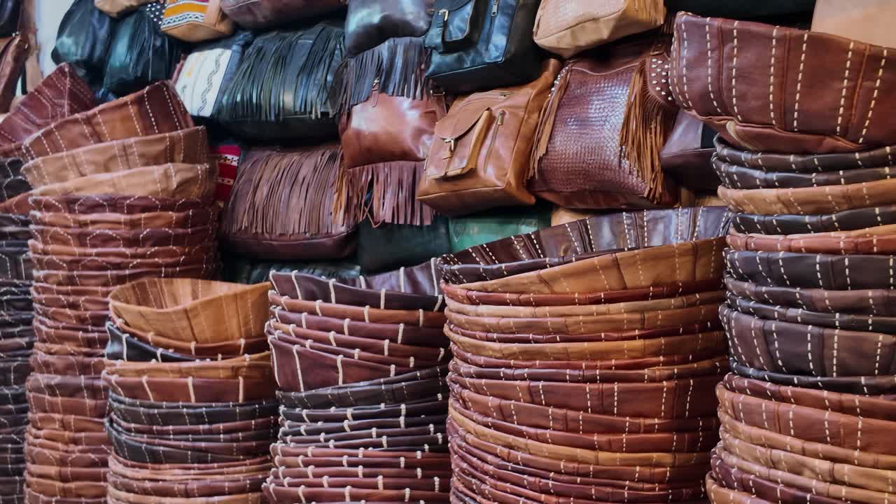 Stacks of handmade leather baskets and bags at Chouara Tannery in Fes Medina