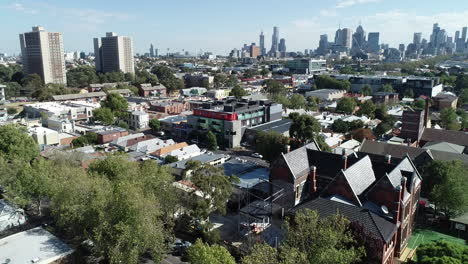 smooth ascend and reveal of melbourne cbd skyline and commission towers with old school in foreground