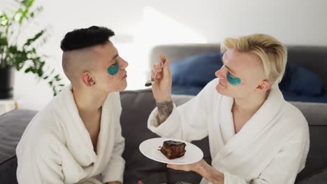 Domestic-homosexual-couple-feeding-each-other-with-cake