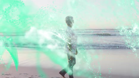 senior woman walking on sandy beach shoreline, showing teal technology data particle overlays