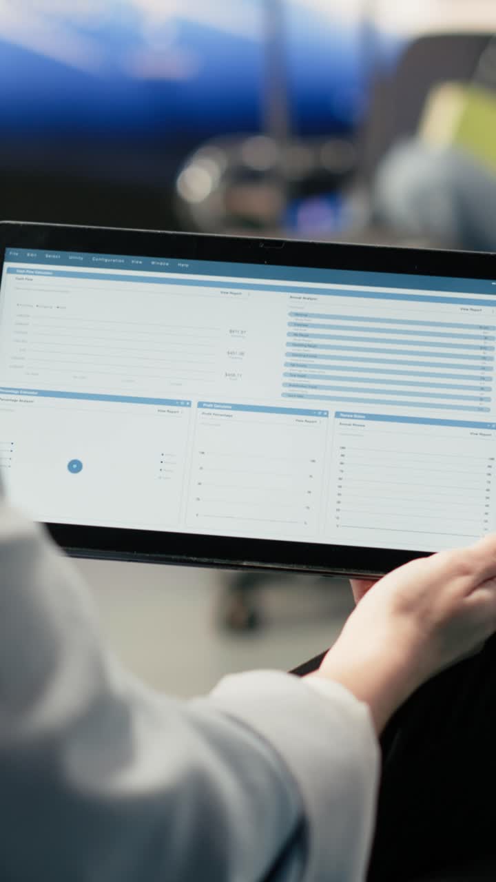 Vertical Video Remote accountant reviewing reports and data charts on laptop in airport