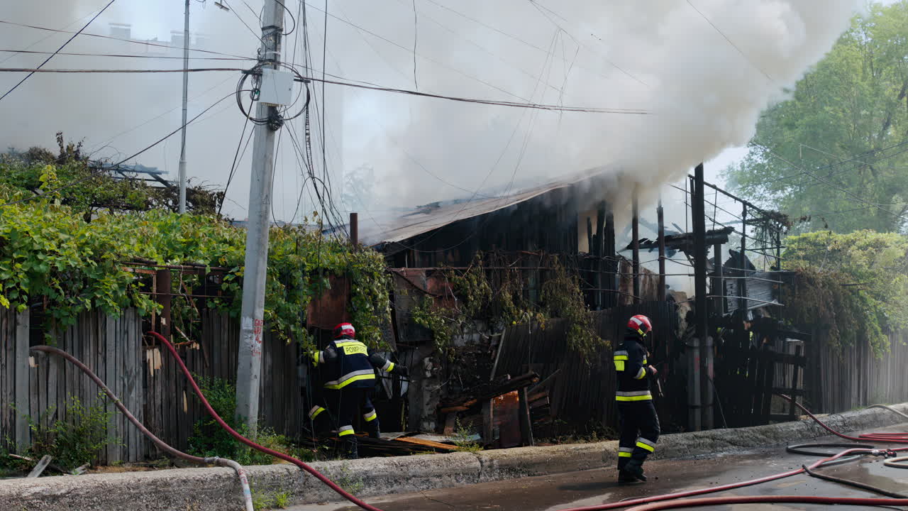 Firefighters trying to extinguish a house on fire