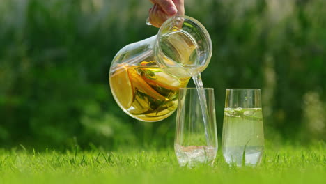 pouring fresh lemonade or iced tea into glasses